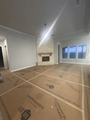 a view of a livingroom with an empty space and a fireplace