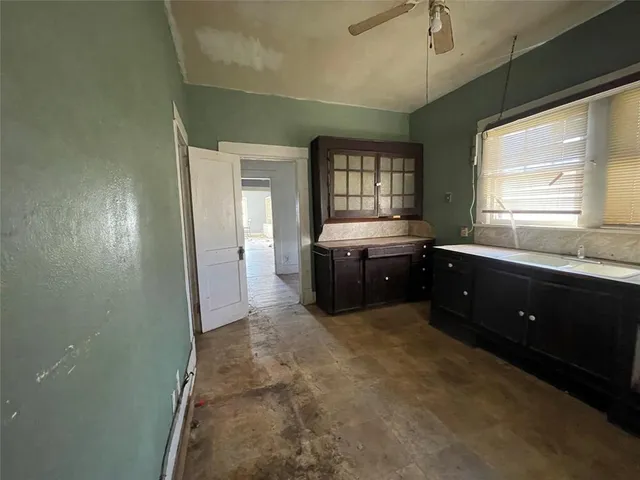 a spacious bathroom with a tub sink and mirror