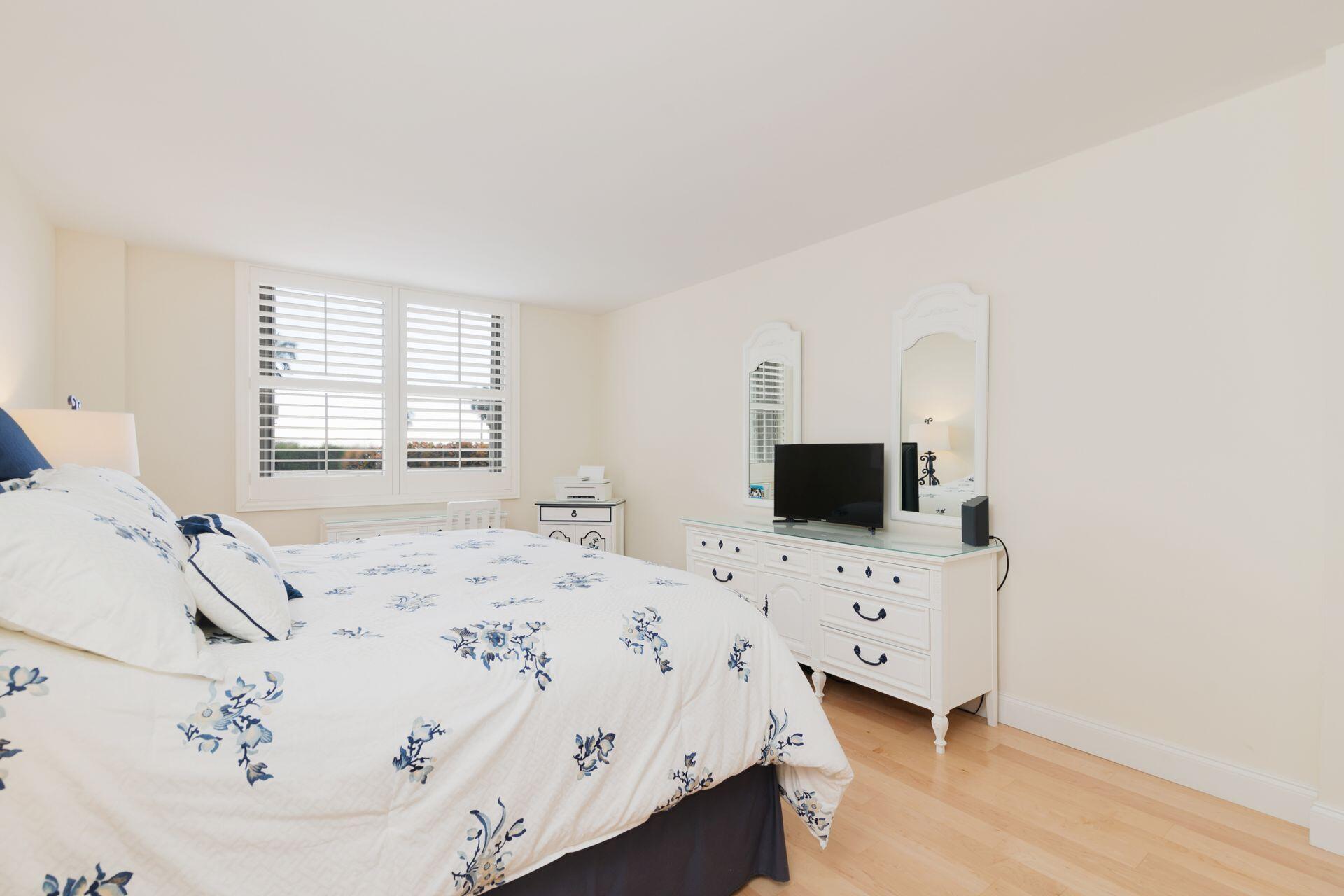 1701 South Flagler Drive, Unit 207 West Palm Beach, FL 33401 - Photo 13 of 26 a bedroom with a bed and a flat screen tv