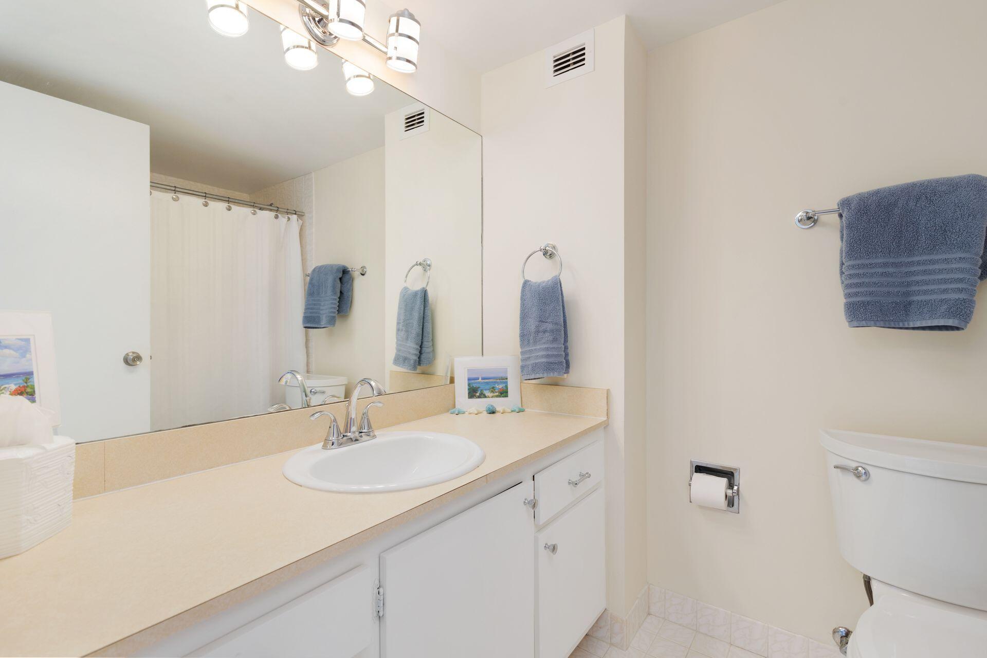 1701 South Flagler Drive, Unit 207 West Palm Beach, FL 33401 - Photo 16 of 26 a bathroom with a sink vanity granite and a mirror