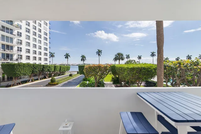 a view of a balcony with a table and chairs