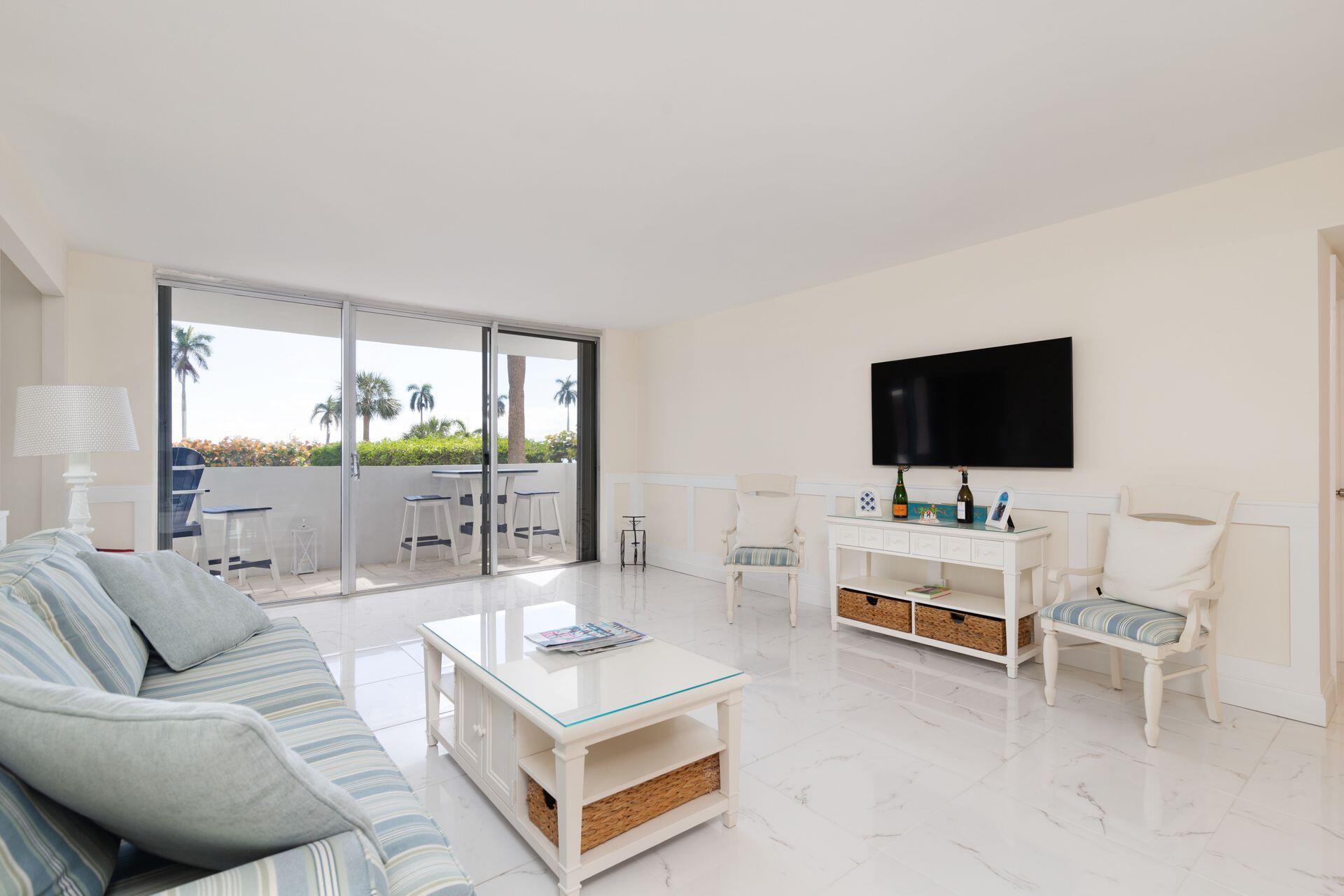 1701 South Flagler Drive, Unit 207 West Palm Beach, FL 33401 - Photo 3 of 26 a living room with furniture and a flat screen tv