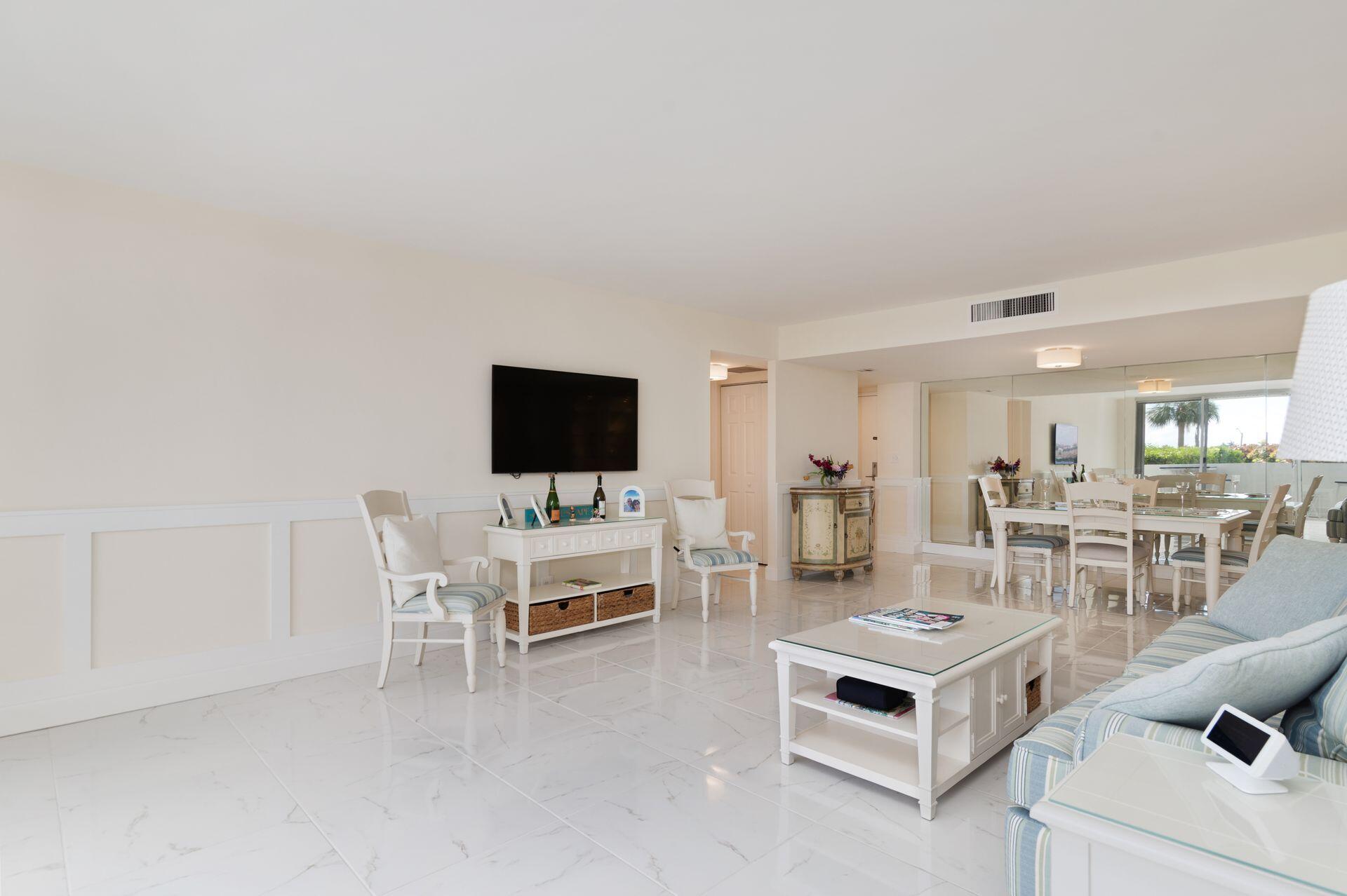 1701 South Flagler Drive, Unit 207 West Palm Beach, FL 33401 - Photo 5 of 26 a living room with furniture and a flat screen tv