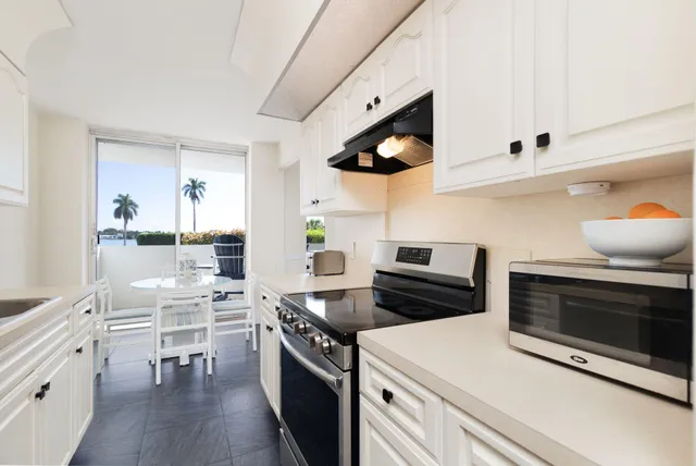a kitchen with a sink cabinets and wooden floor