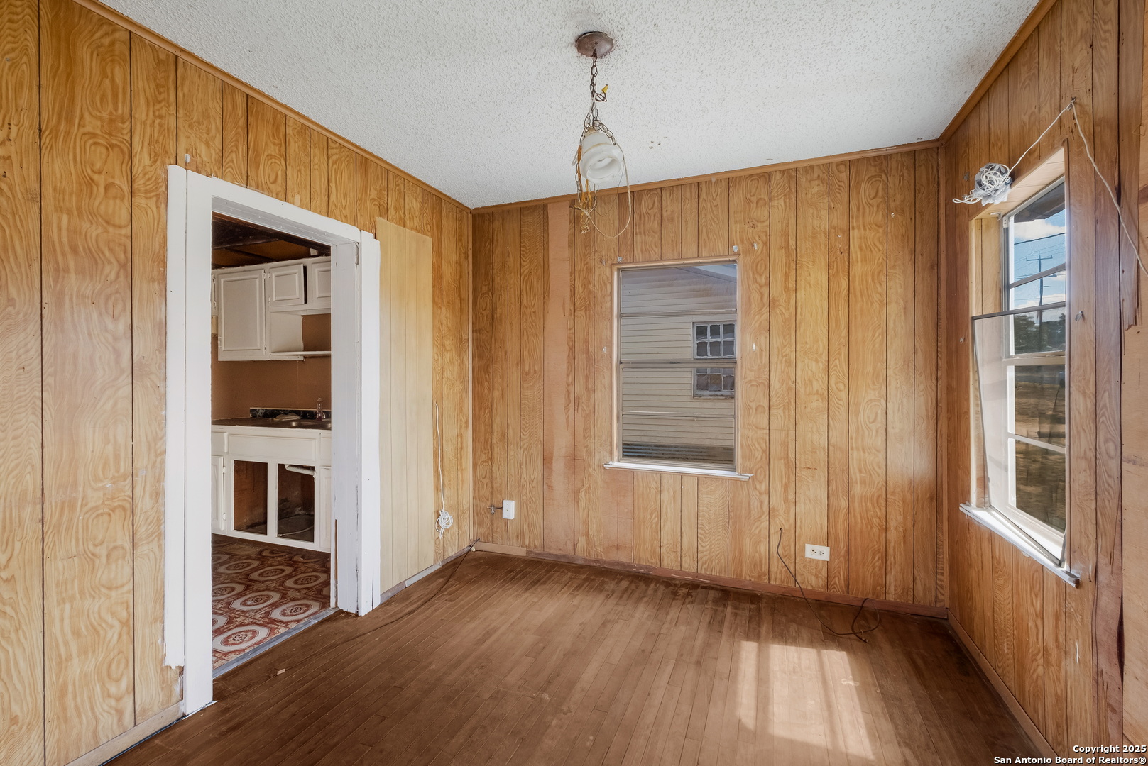 1231 Mogford Road San Antonio, TX 78264 - Photo 19 of 32 a view of a hallway with an entryway and livingroom with wooden floor