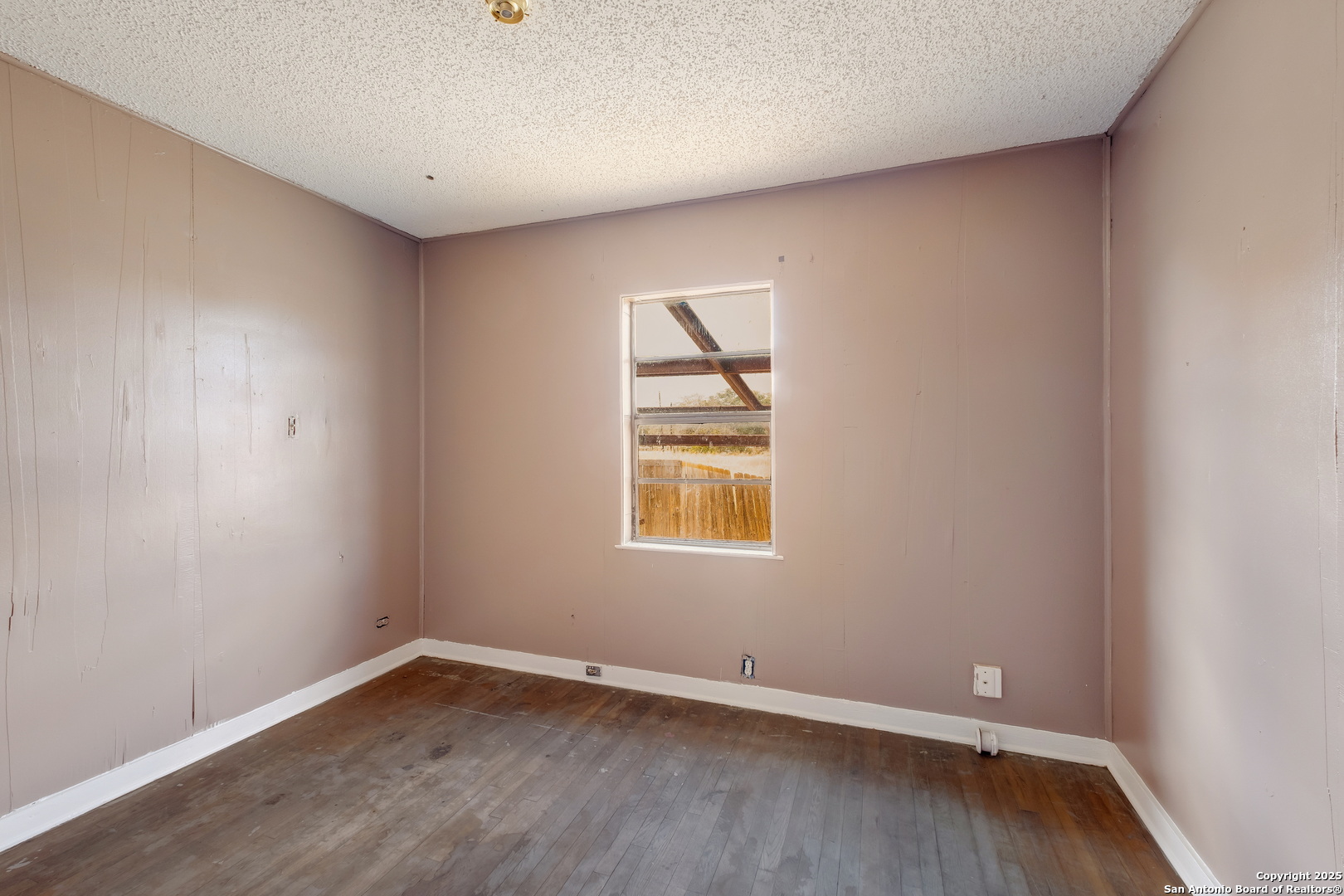 1231 Mogford Road San Antonio, TX 78264 - Photo 22 of 32 an empty room with wooden floor and windows