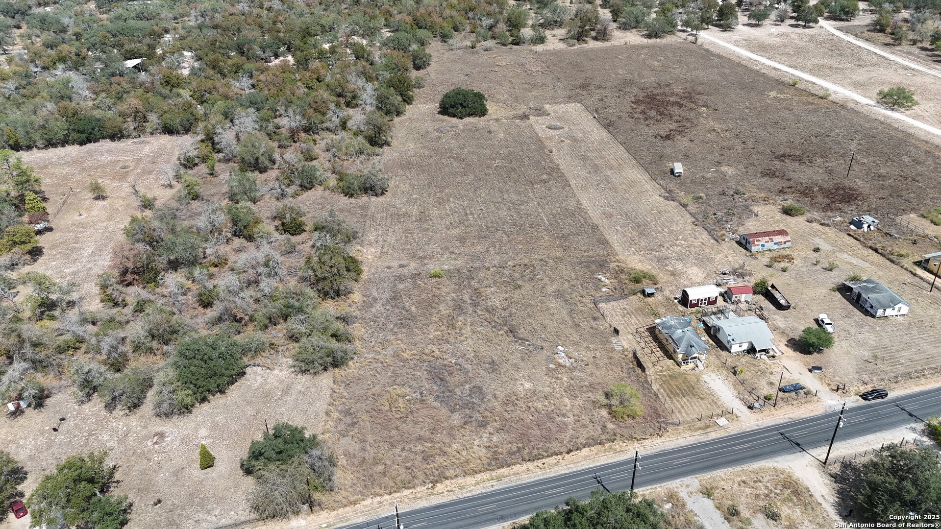 1231 Mogford Road San Antonio, TX 78264 - Photo 30 of 32 a view of a backyard of a house with a road