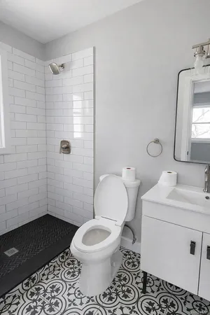 a bathroom with a toilet a sink and shower
