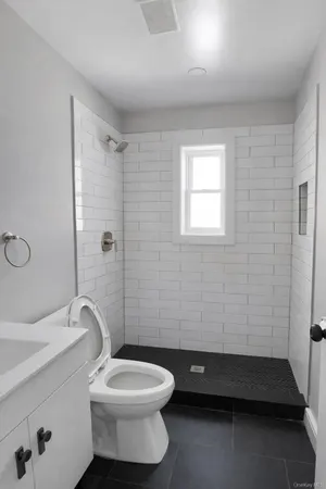 a bathroom with a toilet a sink and shower