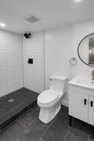 a bathroom with a toilet a sink and a shower