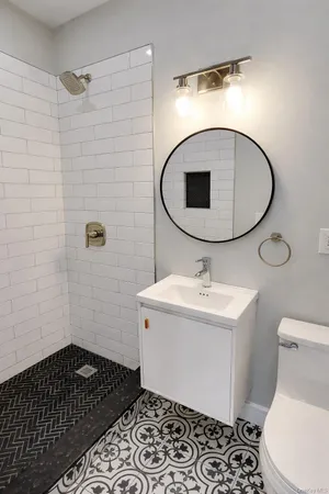 a bathroom with a sink toilet and shower