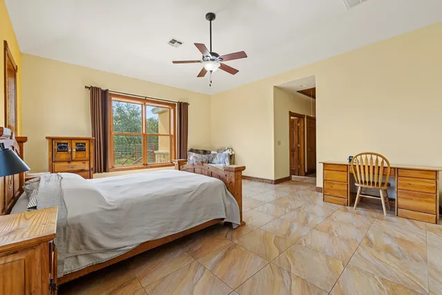 a bedroom with a bed and a chandelier