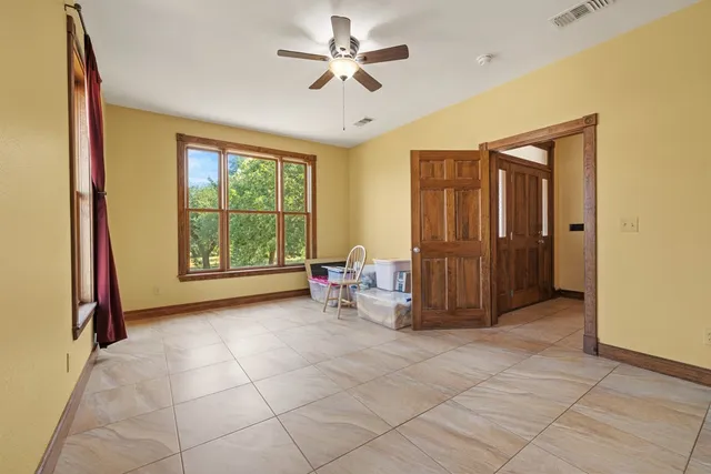 a spacious bathroom with a granite countertop sink and a mirror