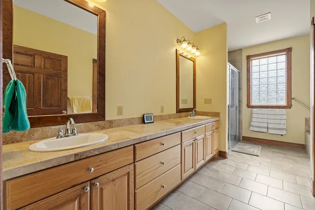 a bathroom with bathtub and window