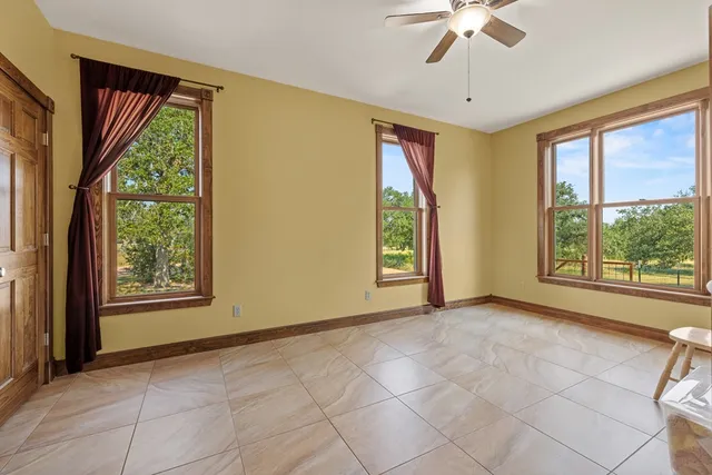 a spacious bathroom with a granite countertop sink and a mirror