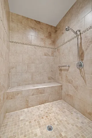 a spacious bedroom with a bed and a chandelier