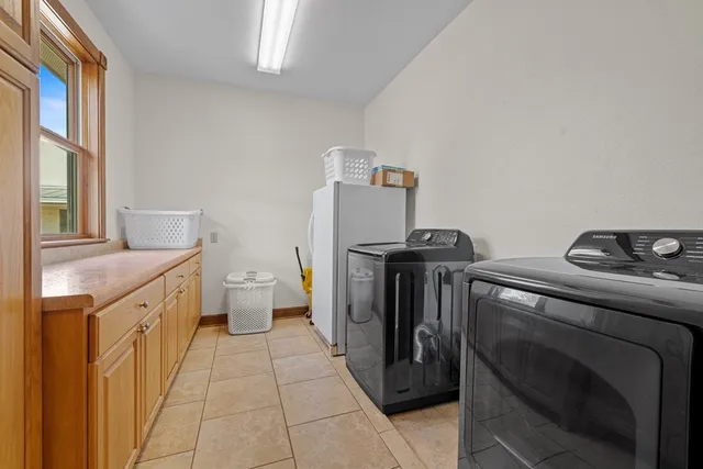a view of storage and utility room with a window