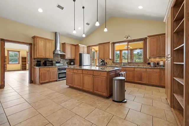 a kitchen with a sink a counter top space appliances and cabinets