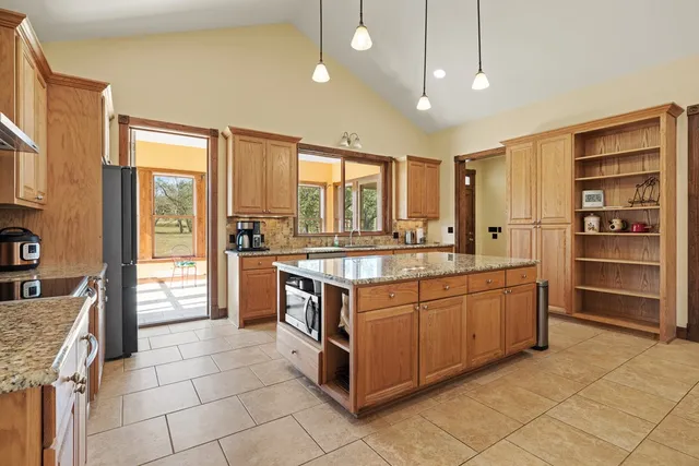 a kitchen with stainless steel appliances granite countertop a stove and a sink