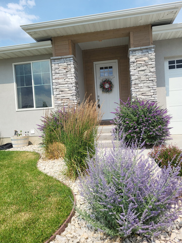 683 Kings Landing Tooele, UT 84074 - Photo 4 of 39 Exterior featuring a white paneled entry door, stone veneer columns, and a stucco facade