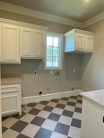 a view of a kitchen with wooden cabinets and a window