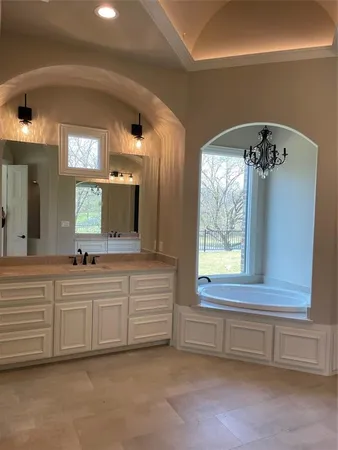 a bathroom with a double vanity sink and a large mirror