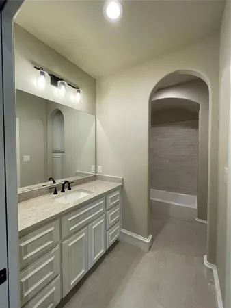 a bathroom with a double vanity sink and a mirror