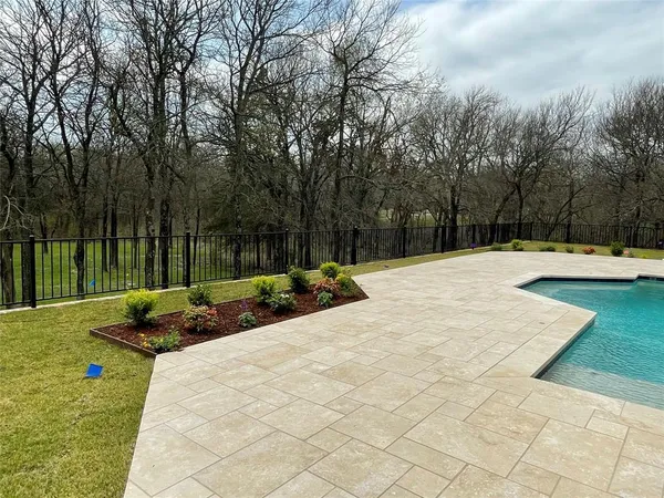 a view of yard with swimming pool and sitting area