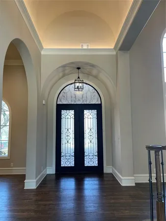 a view of an entryway with wooden floor