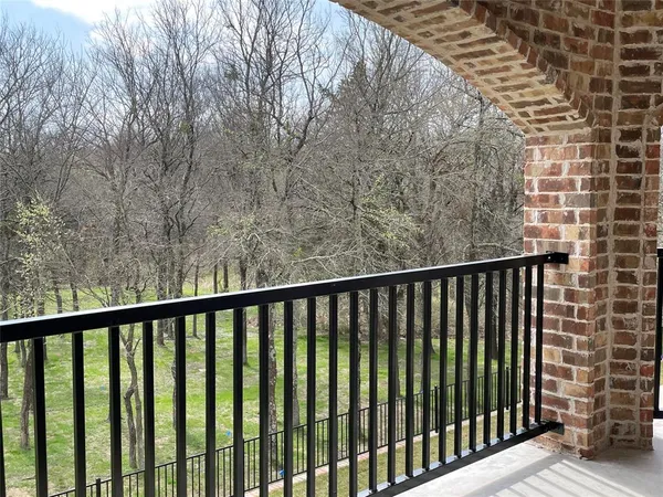 a view of a balcony with wooden floor