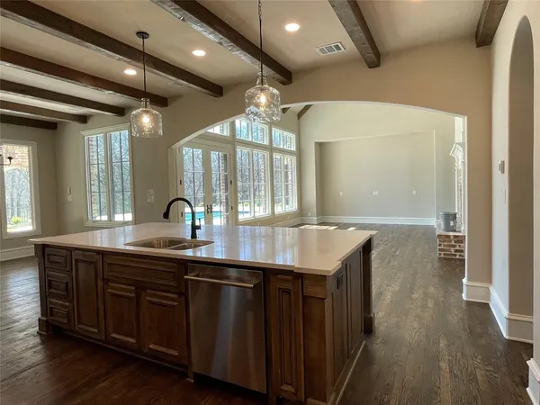 a bathroom with a granite countertop sink a large mirror and vanity