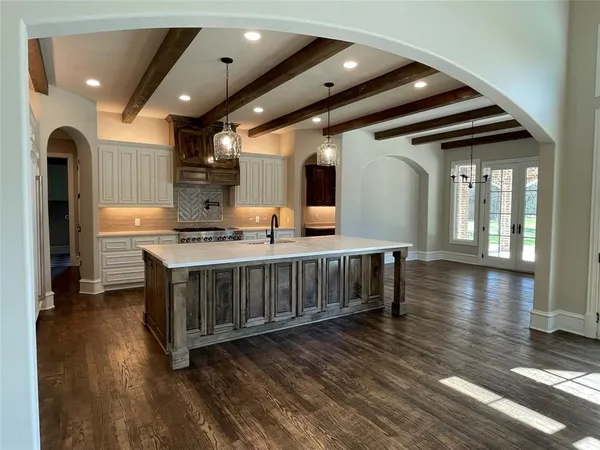 a view of kitchen with cabinets and wooden floor
