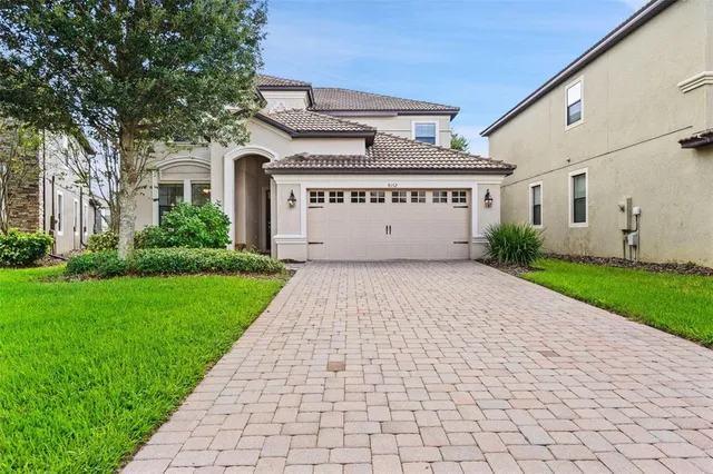 a bedroom with a bed a computer on the desk and a window
