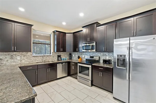 a bedroom with a bed and a flat tv screen on dresser