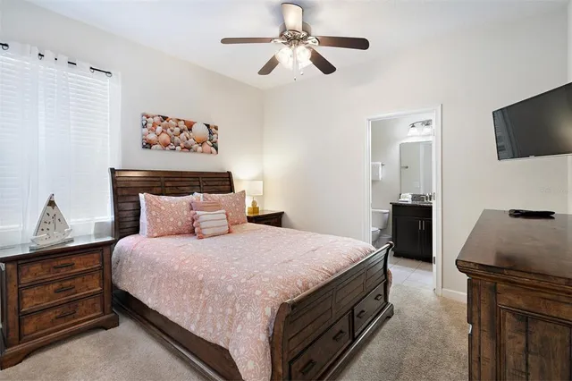 a bathroom with a granite countertop sink toilet a mirror and shower curtain