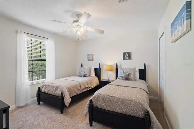 a en suite bathroom with a granite countertop double vanity sink and a mirror
