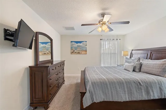a bathroom with a granite countertop sink a mirror and shower