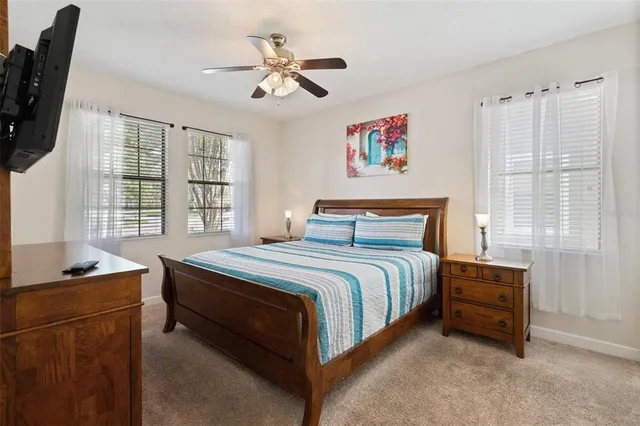 a bathroom with a granite countertop double vanity and a mirror