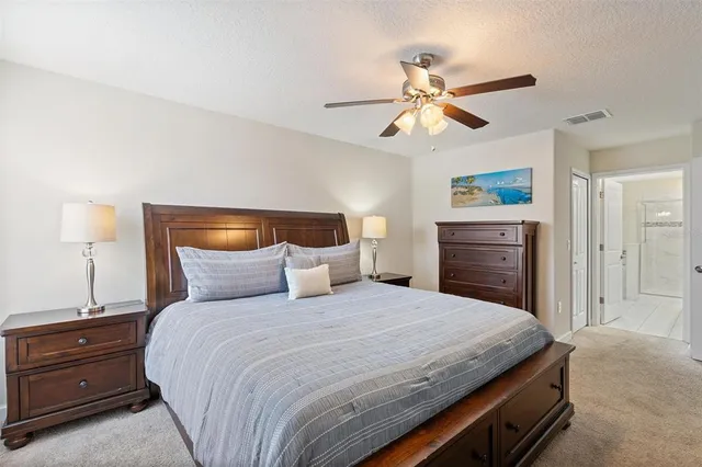 a living room with furniture and paintings on the wall