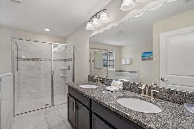 a living room with furniture a large window and wooden floor
