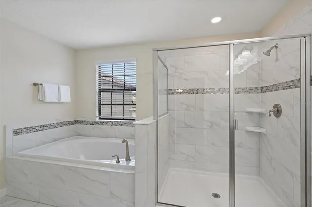 a living room with fireplace furniture and a chandelier