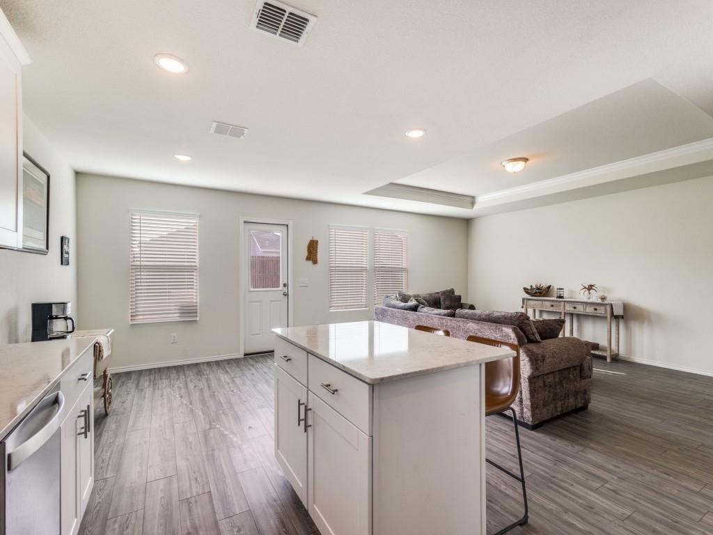 16033 Pemberly Lane Haslet, TX 76052 - Photo 11 of 27 a kitchen with granite countertop a sink and wooden floor