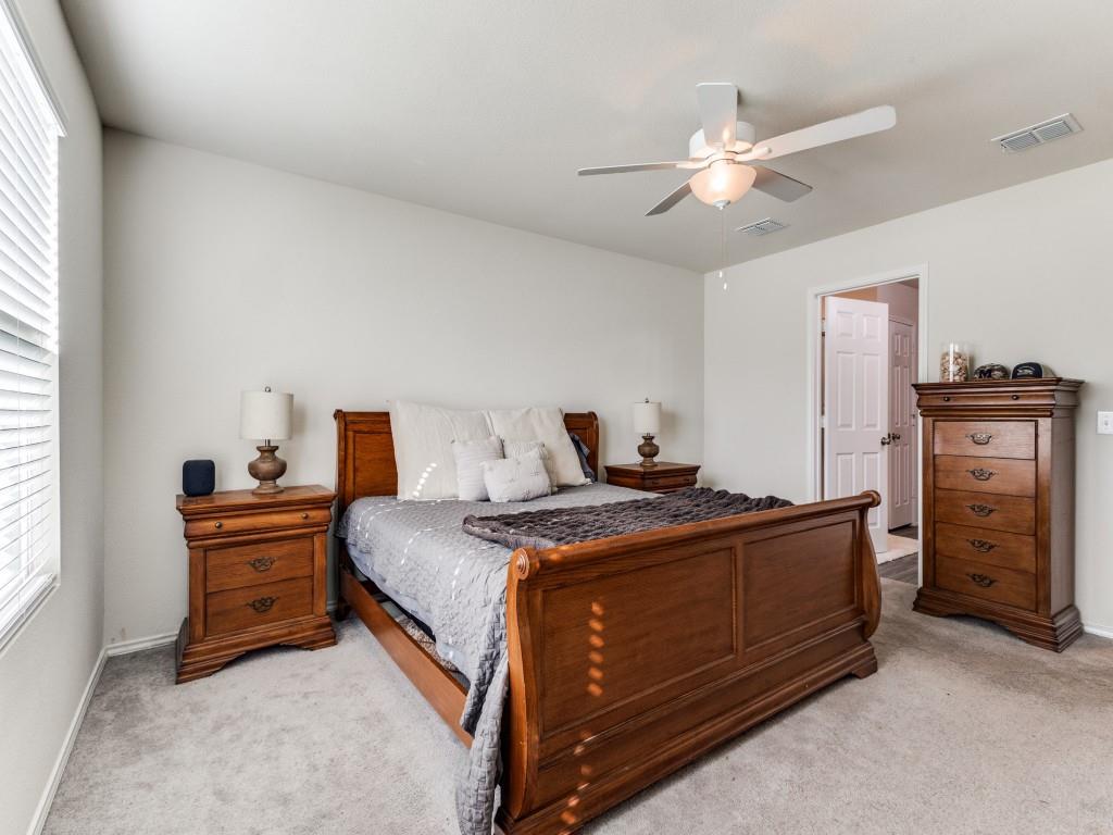 16033 Pemberly Lane Haslet, TX 76052 - Photo 17 of 27 a bed room with a bed and a chandelier