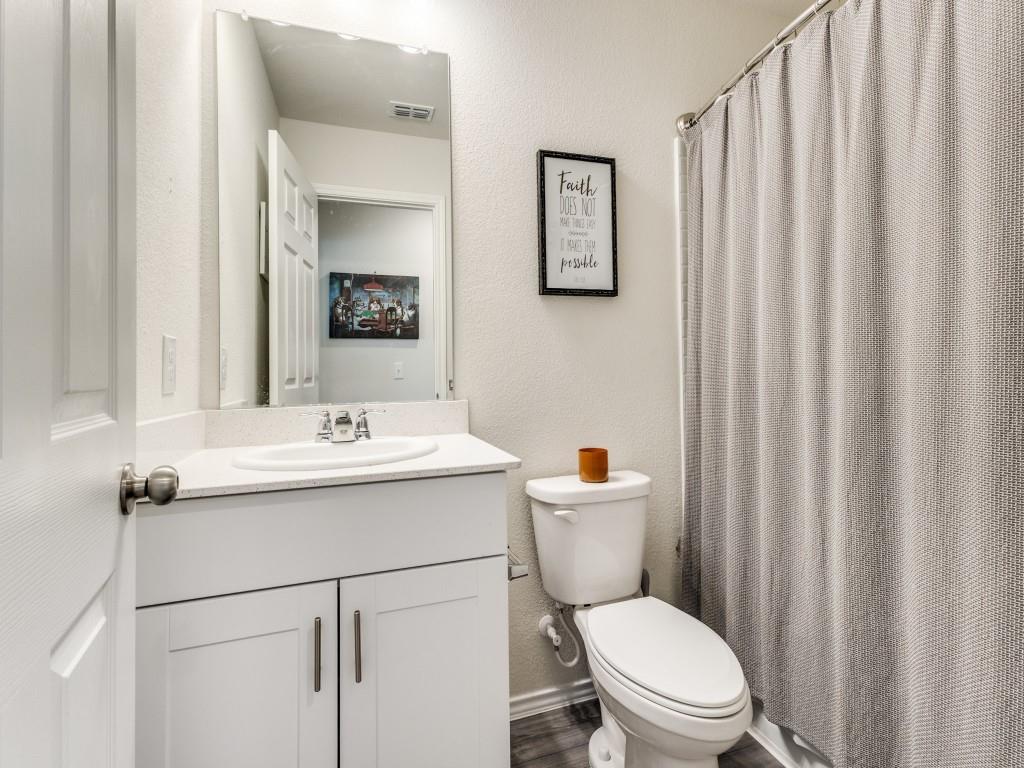 16033 Pemberly Lane Haslet, TX 76052 - Photo 20 of 27 a bathroom with a toilet a sink and a mirror