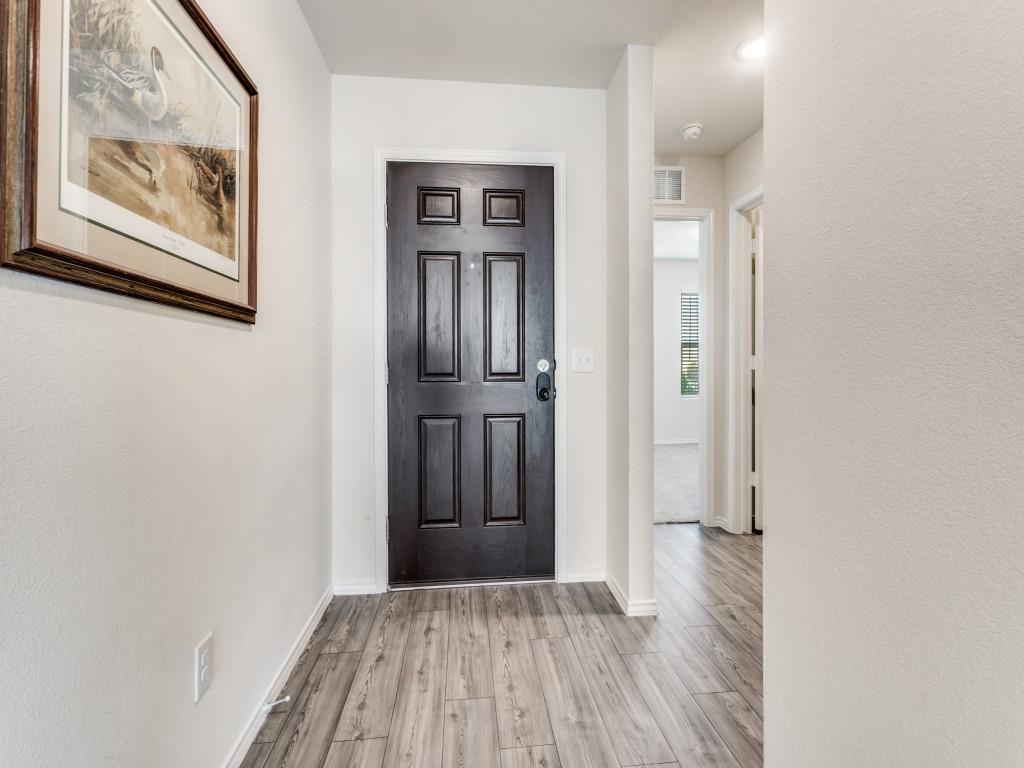 16033 Pemberly Lane Haslet, TX 76052 - Photo 4 of 27 a view of a hallway with wooden floor and closet