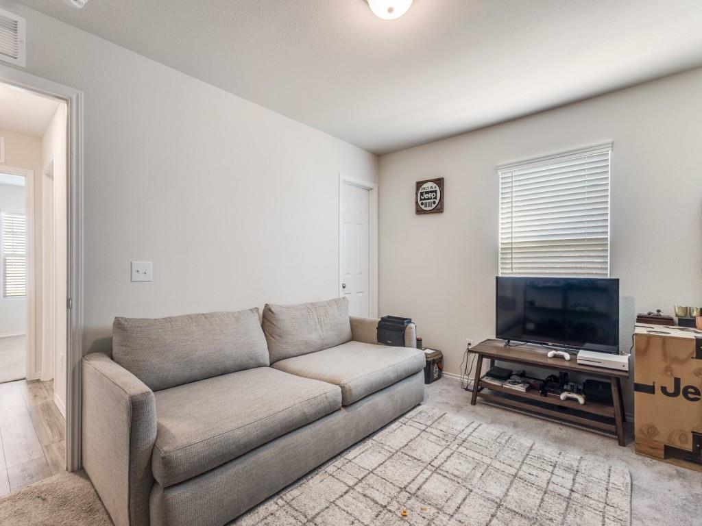 16033 Pemberly Lane Haslet, TX 76052 - Photo 6 of 27 a living room with furniture a flat screen tv and a window