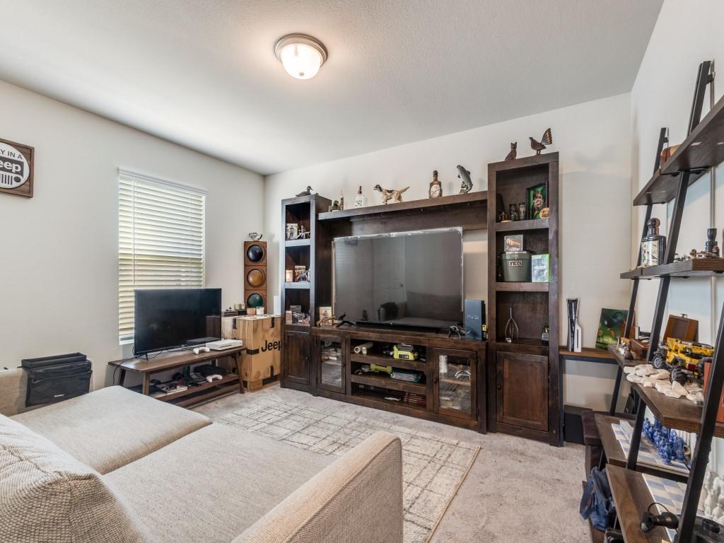 16033 Pemberly Lane Haslet, TX 76052 - Photo 7 of 27 a living room with furniture and a flat screen tv