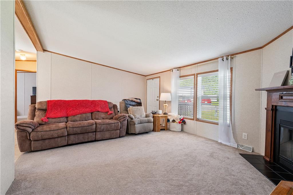 619 Deana Way Rochester, PA 15074 - Photo 3 of 29 Spacious living room boasts oversized windows that flood the space with natural light...with ample room for seating and entertaining this space serves as the heart of the home...where family and friends come together.