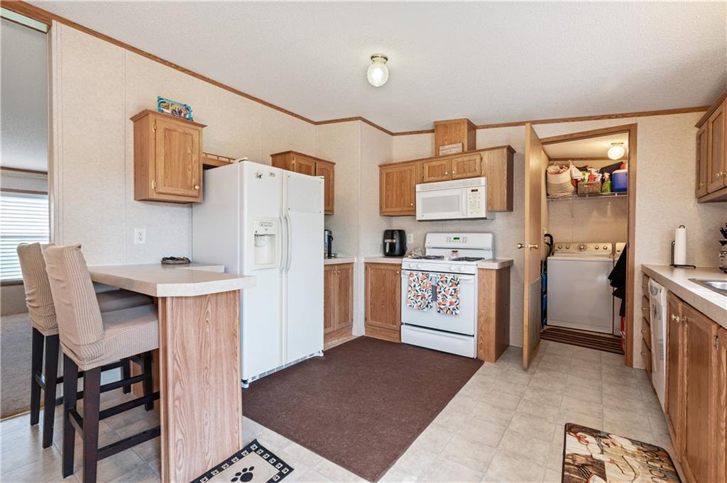 619 Deana Way Rochester, PA 15074 - Photo 9 of 29 Spacious open kitchen with a built in eating area and boasts ample cabinet space plus modern appliances. These neutral tones provide a versatile backdrop allowing for your personal touch!