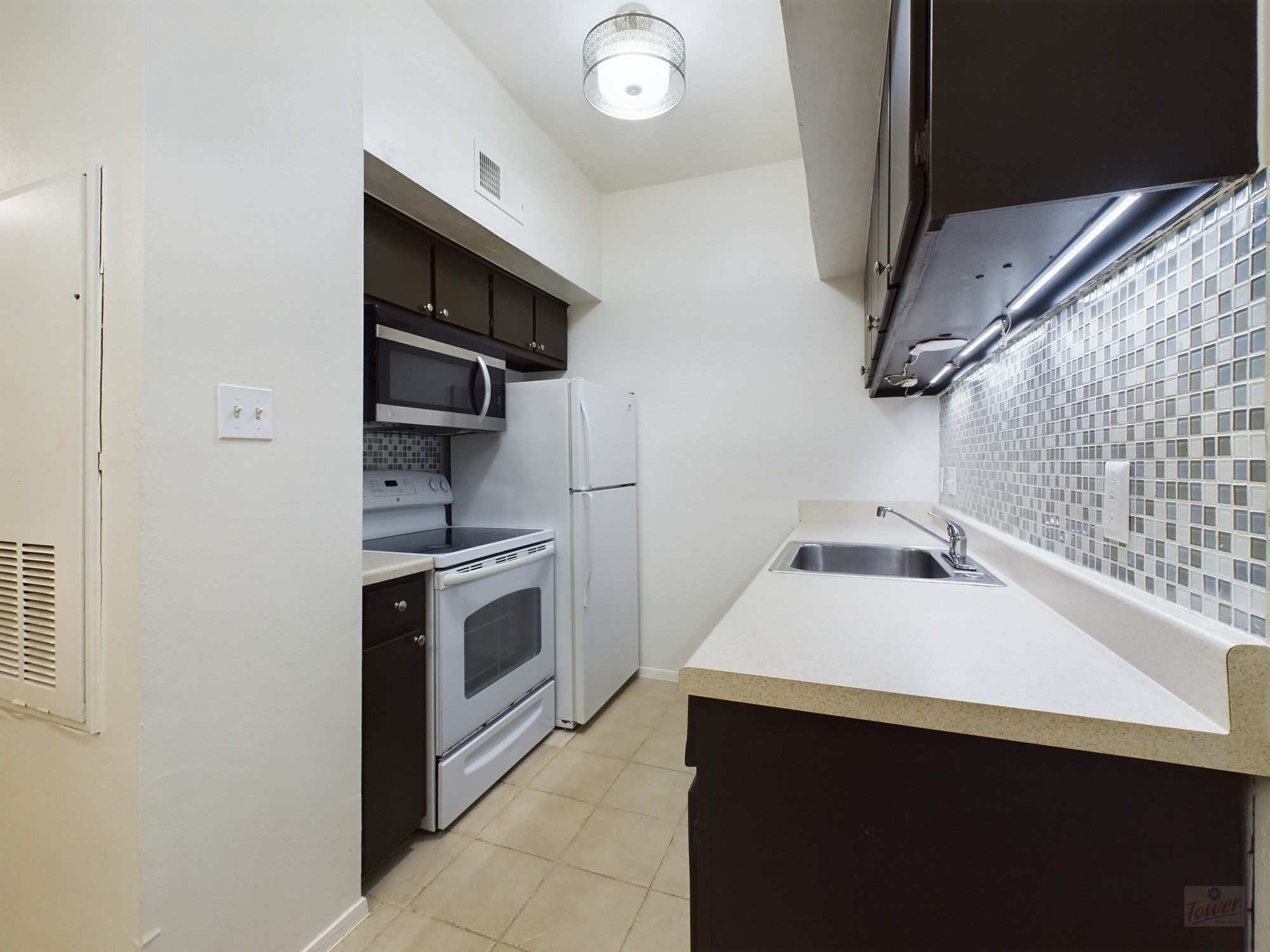 3316 Guadalupe Street, Unit 320 Austin, TX 78705 - Photo 5 of 12 a kitchen with a sink and a stove top oven